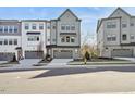 Street view of modern townhomes with attached garages and well-maintained landscaping at 4511 Mint Leaf Ln, Raleigh, NC 27612