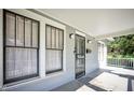 Inviting covered porch features white railings, two windows, and a black decorative security door at 508 S Swain St, Raleigh, NC 27601