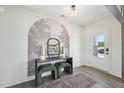 Stylish entryway with decorative wallpaper, console table, mirror, and elegant furnishings at 556 Contempo Dr # 22, Rolesville, NC 27571