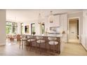 Gourmet kitchen features a large island with seating, white cabinets, pendant lighting, and stainless steel appliances at 5808 Norwood Ridge Dr, Raleigh, NC 27614