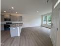 Bright kitchen with gray cabinets, granite countertops, and stainless steel appliances, with ample space and natural light at 6401 Granite Quarry Dr, Raleigh, NC 27610