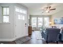 Living room with windows, ceiling fan, modern furniture, and wood flooring at 6401 Granite Quarry Dr, Raleigh, NC 27610