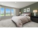 A serene bedroom featuring neutral tones, with large windows providing ample natural light at 6403 Granite Quarry Dr, Raleigh, NC 27610