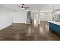 Spacious open-concept living area with hardwood floors, adjacent kitchen with island, and view to the dining area at 7331 Livestock Rd, Mebane, NC 27302