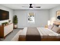Staged main bedroom featuring neutral tones, a ceiling fan, and a view to the backyard at 7331 Livestock Rd, Mebane, NC 27302
