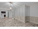 Elegant dining room featuring decorative molding, a stylish chandelier, and plush neutral carpet at 818 Houston Ct, Haw River, NC 27258