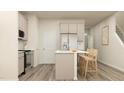 Bright kitchen featuring an island with seating and stainless steel appliances at 874 Pilot St # 5, Haw River, NC 27258