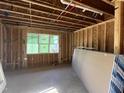 View of framing for a room with a window and exposed utilities, during construction phase at 95 Parkland Dr, Pittsboro, NC 27312