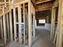 Unfinished interior with exposed framing, electrical wiring, and a view of an open room at 95 Parkland Dr, Pittsboro, NC 27312