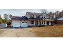 A charming two-story home with a large covered front porch, and a detached two-car garage at 96 Overlook Rd, Cameron, NC 28326