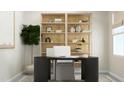 Well-lit home office features a modern black desk, comfortable seating, and a decorative bookshelf at 0 Hanover Way, Sanford, NC 27330
