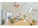 Bright living room with vaulted ceilings, wood floors, and sliding doors leading to a screened in porch at 100 Briar Patch Ln, Chapel Hill, NC 27516