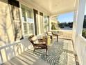 Inviting front porch featuring comfortable seating, stylish decor, and a relaxing atmosphere for enjoying the outdoors at 1025 Chelsea Run Ln, Apex, NC 27502