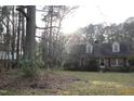 Lush backyard featuring a large grassy area and mature trees at 105 Mary St, Carrboro, NC 27510