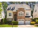 Charming two-story home with a stone facade, attached two car garage and manicured front lawn at 1100 Dotson Way, Apex, NC 27523