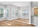 Bright living room with recessed lights, wood floors, lots of natural light and access to the patio at 1100 Dotson Way, Apex, NC 27523