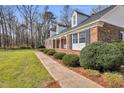 A well-maintained brick home showcasing black shutters and beautifully manicured landscaping at 1192 Princeton Kenly Rd, Kenly, NC 27542