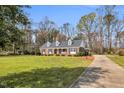 Charming brick home featuring a long driveway and a well-maintained front lawn at 1192 Princeton Kenly Rd, Kenly, NC 27542