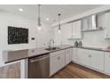 Contemporary kitchen featuring stainless steel appliances, white cabinets, and hardwood floors at 1218 Coach Station Alley # 101, Raleigh, NC 27601