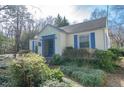 Quaint home featuring blue trim and shutters and mature landscaping, creating a welcoming curb appeal at 1301 Clarendon St, Durham, NC 27705