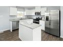 Bright kitchen with stainless steel appliances, granite countertops, a center island and hardwood style floors at 137 Sunny Acres Rd, Garner, NC 27603