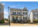 Attractive home showcasing a covered front porch and manicured lawn at 1516 Barn Door Dr, Apex, NC 27502