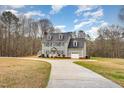 Charming two-story home with blue shutters, gray siding, well-maintained lawn, and attached garage at 205 Fox Hollow Dr, Clayton, NC 27527