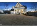 Beautiful two-story home with manicured lawn, two car garage, and inviting front porch with craftsman style columns at 2244 Plowridge Rd, Fuquay Varina, NC 27526