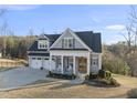 Charming two-story home with a welcoming front porch, two-car garage, and beautifully maintained landscaping at 2244 Plowridge Rd, Fuquay Varina, NC 27526
