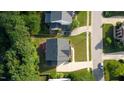 Aerial view of a well-maintained home with a dark roof and lush green surroundings at 229 Shillings Chase Dr, Cary, NC 27518