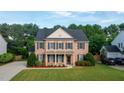 Lovely brick home with a spacious front yard, black shutters, and attached garage at 229 Shillings Chase Dr, Cary, NC 27518