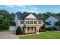 Traditional brick home with black shutters, gabled roof, and well-maintained lawn at 229 Shillings Chase Dr, Cary, NC 27518