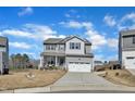 Charming two-story home featuring a covered front porch and a two-car garage at 240 S Stonehaven Way, Clayton, NC 27527