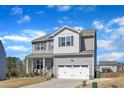 Charming two-story home featuring a covered front porch and a two-car garage at 240 S Stonehaven Way, Clayton, NC 27527