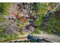Aerial view of the property, showing its location amidst lush greenery and a nearby road at 2408 Homestead Road Rd, Chapel Hill, NC 27516