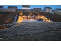 Outdoor backyard stone patio features a cozy fire pit and stylish bar seating, perfect for evening entertaining at 400 Access Dr, Youngsville, NC 27596