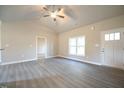 Bright living room showcasing luxury vinyl plank flooring, neutral paint, and a smooth transition to the entryway at 400 S Eastwood Dr, Benson, NC 27504