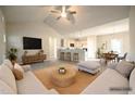 Bright, open-concept living room flows into the kitchen, complete with modern finishes and neutral decor at 400 S Eastwood Dr, Benson, NC 27504