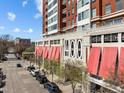 Urban building exterior featuring red awnings and prominent '400' sign, offering a modern living experience at 400 W North St # 900, Raleigh, NC 27603