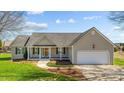 Inviting single-story home boasts a classic design with a front porch and attached two-car garage at 42 Galaxy Dr, Garner, NC 27529