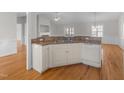Corner kitchen view with ample counter space, white appliances, and wood flooring at 42 Galaxy Dr, Garner, NC 27529