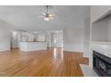 Bright living room with hardwood floors, fireplace, and open floor plan leading to kitchen at 42 Galaxy Dr, Garner, NC 27529
