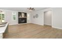 Bright, open-concept living room featuring hardwood floors, a modern fireplace, and plenty of natural light for a cozy atmosphere at 503 Forest Rd, Oxford, NC 27565