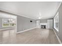 Bright living room showcasing hardwood floors, a fireplace, built-in shelving, and plenty of natural light at 510 Cross St, Sanford, NC 27330