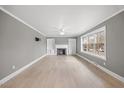 Spacious living room featuring a cozy fireplace, hardwood floors, and ample natural light from large windows at 510 Cross St, Sanford, NC 27330