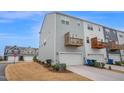 Rear exterior view with garage and upper level decks at 5813 Empathy Ln, Raleigh, NC 27616