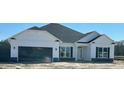 Modern single-story home with black window trim, a dark garage door, and bright white siding at 583 Sweet Potato Lane # 06, Nashville, NC 27856
