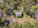 Overhead view of home with a sprawling backyard, mature trees, and detached structure at 6610 Maynard Farm Rd, Chapel Hill, NC 27516