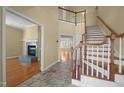 Open foyer featuring hardwood floors, a staircase, and views into living spaces at 6610 Maynard Farm Rd, Chapel Hill, NC 27516