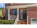 Charming front entrance with a decorative wreath and brick-lined porch, number 705 at 705 Prince Dr, Holly Springs, NC 27540